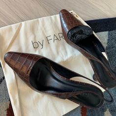 Crafted In Chocolatey, Croc-Embossed Calfskin, These Diana Slingbacks From By Far Add Class To Any Look. With A Pointed Toe, Square-Cut Vamp And An Angular, Conical Heel, These Are Versatile, Stylish Pumps You'll Want To Wear All Day. 100% Italian Soft Leather Insole 100% Luxurious And Extremely Soft Italian Polished Goatling Leather Heel Measures About 7cm / 2.95 Inches. There Is A Matching By Far Bag In My Profile. Chic Leather Slingback Pumps With 4-inch Heel, Office Calf Leather Slingback Pumps With Almond Toe, Brown Closed Toe Slingback Pumps For Work, Luxury Brown Slingback Pumps For Work, Leather Slingback Pumps For Work With Almond Toe, Designer Leather High Heel Slingback Pumps, Brown Closed Toe Slingback Pumps With Branded Heel, Chic Leather Slingback Pumps With Round Toe, Chic Brown Slingback Pumps Medium Width