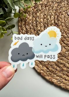 someone is holding up a sticker that says bad days will pass on the front