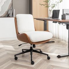 an office chair sitting in front of a desk with a laptop computer on top of it