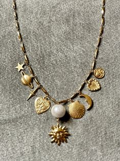 "Sun" necklace features a curated selection of vintage brass charms from the 60s, 70s and 80s from France, Italy, and the United States. Charms are finished with a layer of Renaissance wax, the same finish used by art conservators in British Museum. "Sun" necklace measures 16" - 18" long on an adjustable chain. Alaska Young, Galaxy Earrings, Sun Charm, Sun Necklace, Moody Wedding, France Italy, Golden Sun, Repurposed Vintage, Thrift Finds