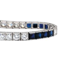 This wonderful vintage piece features 9.80ctw of vibrant blue sapphires combined with 5.30ctw of sparkling round brilliant cut diamonds. The diamonds are graded G-H in color and VS1-2 in clarity and form a beautifully dramatic contrast to the deep blue sapphires. A stunning Mid Century era treasure set in platinum, this bracelet fastens securely with a push style clasp, and has a hidden safety latch. This bracelet measures 7.25 inches long. It has been independently appraised at a value of $25,0 Luxury Blue Diamond Bracelet, Classic Sapphire Bracelets For Formal Occasions, Classic Blue Diamond Bracelet For Formal Occasions, Timeless Blue Diamond Bracelet, Luxury Sapphire Tennis Bracelet With Diamond Accents, Luxury Blue Diamond Bracelet With Brilliant Cut, Blue Diamond Bracelet With Brilliant Cut Luxury Style, Brilliant Cut Sapphire Bracelet For Wedding, Wedding Sapphire Bracelet With Brilliant Cut Diamond