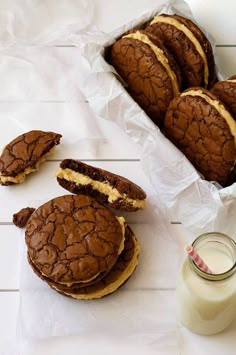 some cookies and milk on a white table