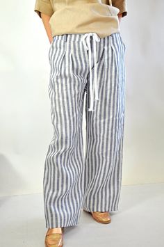 "Wide Legged Linen Trousers with Belt and Pockets, High Waisted Pants, Summer Palazzo Pants, Beach Pants for Women, Striped Pants for Ladies Natural Linen stiped pants. Summer Loose Drop crotch  Pants. Loose linen pants. Every day  comfortable pants.  Maxi trousers. Cool casual pants. Striped  100% lINEN pants.  Comfortable and Relaxed. Zipped pants. Model wearring size S Color : Striped blue/ white   Fabric: Linen 100% The style I used was originally designed and professionally constructed by me. Each item of my shop has a special package. Handmade in a pet-free and smoke- free environment. Size chart Gabyga: XS (US 2, UK 6) Bust: around 33.5\" / 85 cm Waist: around 26\" / 66 cm Hips: around 36\" / 91 cm Height: 5'3\" / 160 cm S (US 6, UK 10) Bust: fits Bust around 35.5\" / 90 cm Waist: f Striped Straight Pants For Beach, Striped Trousers For The Beach, Striped Pants For The Beach, Striped Linen Beach Pants, Striped Beach Trousers, Linen Striped Pants, Long Linen Pants, Loose Linen Pants, Trousers With Belt