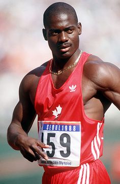 a man running in a race with his hands on his hips