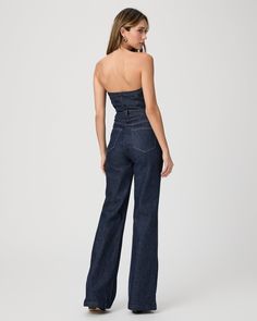 The must have one-piece of the season. Inspired by our Leenah wide leg silhouette, this strapless jumpsuit is crafted from super soft dark wash denim with a hint of stretch for comfort and features silver front buttons, elastic at the back, and light boning in the bodice. The Sansa Jumpsuit pairs perfectly with boots, heels, or flats. | Sansa Jumpsuit - Calix Blue | Size 6 Strapless Fitted Denim Jumpsuits And Rompers, Fitted Denim Strapless Jumpsuits And Rompers, Strapless Fitted Denim Jumpsuits, Denim Strapless Jumpsuit With High Waist, Chic Strapless Denim Jumpsuits And Rompers, Chic High Rise Strapless Jumpsuit, Chic Dark Wash Straight Leg Denim Jumpsuit, Wide Leg Denim Strapless Jumpsuit, Fitted Wide-leg Dark Wash Jumpsuits And Rompers