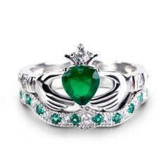 Celebrating love, beauty and Irish culture, this claddagh ring set will capture your heart at first sight. Crafted in sleek sterling silver, the ring features an emerald green heart center stone set on a high polished shank. The traditional claddagh ring is a meaningful token of loyalty, friendship and love. The hands represent friendship, the heart represents love and the crown represents loyalty.With the beautiful coordinating band, the ring is a dazzling look of love.Carat Weight: 1.4 ctStone Green Fine Jewelry Heart Ring For Wedding, Green Heart Cut Rings For Wedding, Green Heart Cut Wedding Rings, Green Heart Ring For Wedding With May Birthstone, Green Heart Ring For May Birthstone Wedding, Green Heart Ring For Wedding, May Birthstone, Green Heart Ring For Wedding And May Birthstone, Green Heart Cut Jewelry For Anniversary, Green Heart Cut Jewelry For Wedding