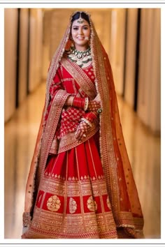 a woman in a red and gold bridal gown