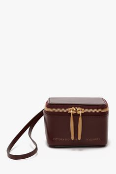 A reflection of Victoria’s passions for fashion, beauty and travel, the Vanity Micro bag is a refined addition to the house’s new series of micro volumes. Crafted from a glossy but robust Burgundy calf leather and with a softly curved silhouette and elegant wristlet strap, it mixes masculine and feminine beautifully. Design features include microsuede lining, a double zip opening and signature gold branding, which includes the discretely stamped address of Victoria’s London studio (N.202) follow Masculine And Feminine, Micro Bag, Gold Branding, New Series, Designer Outfits Woman, Victoria Beckham, Passion For Fashion, Calf Leather, Design Features