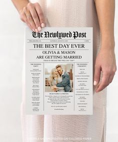 a person holding up a newspaper with the front page showing an image of a man and woman