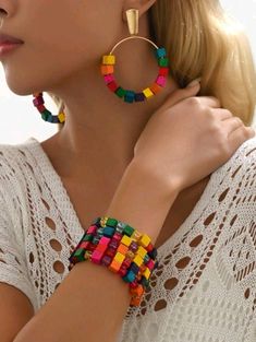 Elevate your summer style with this stunning Boho Bracelet Stack and Matching Earrings Set. Crafted with vibrant, colorful wood cubes, this exquisite jewelry collection adds a playful and elegant touch to any outfit. The set includes a versatile stack of beaded bracelets and a pair of coordinating dangle earrings, perfect for expressing your unique fashion sense. Designed for women and teen girls, this accessory set is ideal for a variety of occasions including daily wear, summer vacations, beac Vibrant Rainbow Jewelry With Colorful Design, Multicolor Summer Beach Jewelry, Colorful Bohemian Jewelry For Vacation, Vibrant Beaded Summer Jewelry, Trendy Multicolor Jewelry For Vacation, Multicolor Summer Jewelry For Vacation, Trendy Multicolor Beach Jewelry, Trendy Multicolor Vacation Jewelry, Multicolor Summer Jewelry