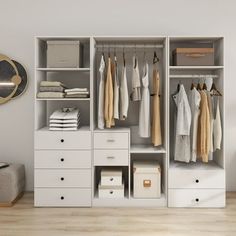 a white closet with drawers and clothes hanging on it