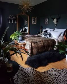 a bedroom with green walls, leopard print rugs and gold accents on the bed