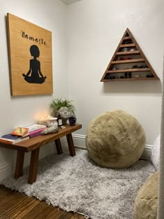 a room with a large bean bag on the floor next to a wooden table and shelf