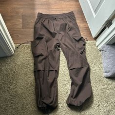 Never Worn! They Are Men’s Size Xl But They The Waist Band Is Stretchy And Adjustable For Waist Sizs 29-40!! Brown Casual Parachute Pants With Relaxed Fit, Brown Pants With Elastic Waistband For Casual Wear, Sporty Brown Bottoms For Streetwear, Casual Brown Parachute Pants With Loosely Fitted Hips, Brown Relaxed Fit Bottoms For Outdoor Activities, Casual Brown Relaxed Fit Parachute Pants, Casual Brown Parachute Pants For Outdoor, Urban Drawstring Long Pants, Utility Style Brown Bottoms For Outdoor Activities