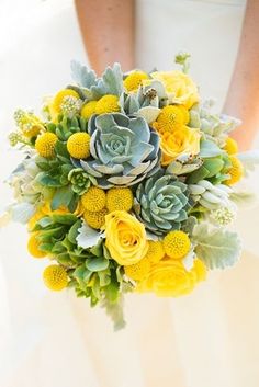 a bridal bouquet with yellow flowers and succulents