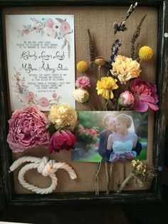 an old frame is decorated with flowers and photos for a wedding or special occasion to the couple