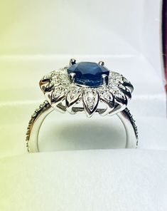 Beautiful 14k White Gold Natural Sapphire and Diamond Ring : Natural Sapphire: 3.12 CT Side Diamonds: 0.50CT Color: G Clarity: SI1 Total ring weight: 6.2GR 14K White Gold Free Ring sizing available For more information regarding this item feel free to reach me so I can accommodate your needs. Thank you Anniversary White Gold Flower Ring With Gemstone, Silver Sapphire Ring In 14k Gold, Silver-finished 14k Gold Flower Ring For Anniversary, 14k Gold Silver Flower Ring For Anniversary, Anniversary 14k Gold Flower Ring, White Gold Hallmarked Flower Ring, Silver 14k Gold Round Cluster Ring, Fine Jewelry White Gold Flower Ring With Center Stone, White Gold Flower Ring In Fine Jewelry Style