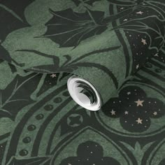 a green and black wallpaper with stars, leaves and swirls on the background