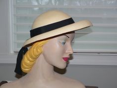 Really great 1940's Panama hat. It is a nice creamy beige with a pale yellow hue. Not white. It has a round crown with a deep u at the bottom between crown and brim. The brim is turned down all around. I do not know if this is the supposed shape but this was kept in a hat box since it was bought. I would like the front brim to be flat and turned down like a fedora. Not sure it that could be done I personally not attempt it although I have seen UTube videos on this. The hat looks good as is on fo Cream Cloche Hat With Short Brim For Church, Cream Cloche Hat With Curved Brim For Church, Vintage Beige Hat With Short Brim, Retro Beige Hat With Curved Brim, Retro Beige Short Brim Hat, Retro Cream Hat With Curved Brim, Cream Brimmed Straw Hat For Church, Brimmed Cream Straw Hat For Church, Beige Brimmed Cloche Hat For Formal Occasions