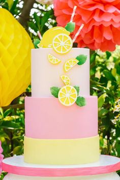 a three tiered cake decorated with lemons and leaves