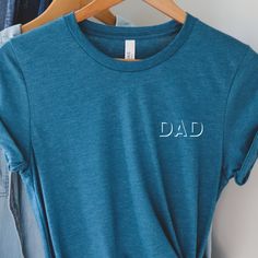 Dad Pocket Tshirt, Funny dad shirt, Fathers Day Gift, New Parents, Gift for Dad, funny Dad Tshirt, Trendy larger sizes available upon request ----ABOUT OUR TEES----- Our tees fit like a well-loved favorite, featuring a crew neck, short sleeves and designed with superior Airlume combed and ring-spun cotton that acts as the best blank canvas for printing. Key Features: - Heat transfer vinyl print - Retail fit - Side seamed - Shoulder taping - Fitted at bicep - Tear-away label - Unisex, women, yout Blue Relaxed Fit T-shirt For Father's Day, Father's Day Blue Top With Funny Text, Funny Letter Print T-shirt For Father's Day, Father's Day Casual Pre-shrunk Shirt, Father's Day Funny Text Cotton T-shirt, Father's Day Family Cotton T-shirt, Blue Tops With Text Print For Father's Day, Father's Day Gift Tops With Letter Print, Blue Cotton T-shirt For Father's Day