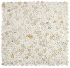 a white and beige tile with pebbles on it