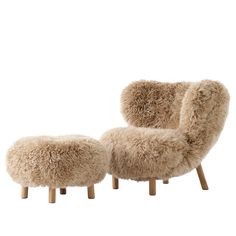 a sheepskin chair and footstool are shown in front of a white background