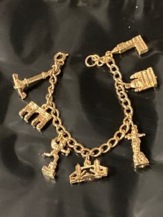 Souvenir of London Gold tone chunky chain link charm bracelet 17cm great condition. Gold Charm Bracelet As A Souvenir, Metal Charm Bracelet Costume Jewelry, Metal Chain Link Charm Bracelet With Lobster Clasp, Gold Metal Bracelet With Charms, Nickel-free Metal Chain Link Charm Bracelet, Collectible Metal Charm Bracelet With Lobster Clasp, Metal Charm Bracelet With Dangling Chain, Collectible Vintage Charm Metal Bracelet, Metal Link Charm Bracelet With Lobster Clasp