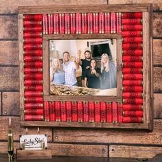 a photo frame made out of red candles