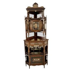 an antique wooden corner cabinet with glass doors