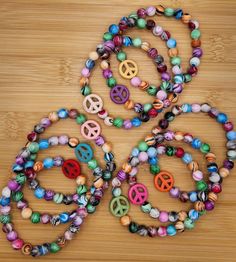 Peace sign multi color stretch stack boho bead bracelets - pick your favorite bohemian color.  Each bracelet is 7 1/2 inches long.  Created by Kelly in the USA! Please do not over stretch, may result in breakage.  Never leave small children unattended with items containing small pieces, potential choking hazard.  Beads may change colors over time if worn in water or while applying products to the skin such as lotions. Check out my Etsy store for bracelets and more Kellyanndesigsgifts.etsy.com Adjustable Bohemian Stretch Bracelet With Wooden Beads, Hippie Friendship Bracelets With Round Beads, Bohemian Stretch Bracelet With Wooden Beads, Hippie Hand-strung Friendship Bracelets With Round Beads, Hand-strung Hippie Friendship Bracelet With Round Beads, Bohemian Friendship Bracelets With Wooden Beads Gift, Bohemian Friendship Bracelets With Wooden Beads, Assorted Bohemian Jewelry For Festivals, Bohemian Assorted Jewelry For Festivals