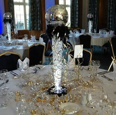 there is a disco ball on top of the table in this room with silver and gold decorations