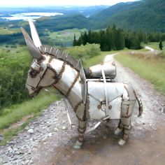 an animal made out of metal sitting on top of a dirt road