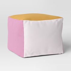 a pink, yellow and white square ottoman