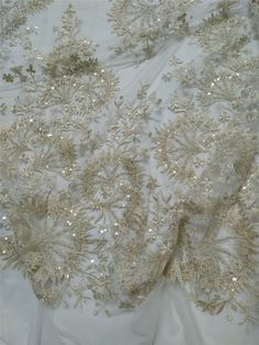 "This stunning Lace Fabric design piece has soft hand feel, It's perfect for weddings, bridal parties, and any events. Shop our large inventory of bridal fabrics. ☆PRODUCT DESCRIPTION : This gorgeous fabric is made on a sheer base with a beautiful vintage embroidery and delicate beaded throughout. The fabric width is approximately 51\" (130cm) Wide. Color: light champagne as in picture Material: Rayon, Polyester，Sequins, Pearls ☆ PURCHASING INFORMATION: This fabric is sold by the yard and each Q Elegant Embellished Embroidered Fabric For Mother Of The Bride, Elegant Embellished Fabric For Mother Of The Bride, Elegant Embroidered Sequin Fabric For Wedding, Elegant Gold Embroidered Fabric For Wedding, Elegant Wedding Fabric With Gold Embroidery, Elegant Cream Sequin Fabric With Pearl Embroidery, Elegant Wedding Sequin Fabric With Pearl Embroidery, Elegant Cream Embroidered Fabric With Sequins, Glamorous Sequin Fabric With Intricate Embroidery For Wedding