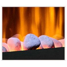 some white rocks sitting in front of a fire