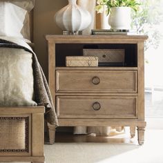 a bedroom scene with focus on the nightstand and bed