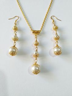 Gold pearl Victorian jewelry set Wedding gold set necklace earrings gold Boho jewelry set Bridal pearl jewelry set Gift pearl set earrings Beautiful Set of gold tone filigree ornaments and white crystal pearl's beads and glass pearl beads pendant necklace and earrings. Antique style filigree gold tone set necklace and earrings . Gold tone glass pearls Bohemian necklace and earrings . Boho necklace . Boho jewelry set . Boho pearl earrings . Bohemian necklace and earrings . Birthday set  necklace and earrings . Gold-tone Ibiza style jewelry set . Bridal jewelry set. Jewelry set for wedding. Birthday gift set. Wedding pearl jewelry set. Bridal jewelry set. This set is a beautiful Gift for Girlfriend, for sister, for mother,for bridesmaids or Maids of Honor, or for yourself.  Gift jewelry set. Wedding Filigree Jewelry Sets, Elegant Pearl Jewelry With Gold Beads, Wedding Jewelry Sets With Filigree, Elegant Gold Jewelry With Gold Beads, Elegant Gold Bridal Necklace With Gold Beads, Elegant Gold Dangle Jewelry Sets, Gold Jewelry With Pearl Charm For Formal Occasions, Elegant Gold Bead Wedding Jewelry, Formal Gold Jewelry With Pearl Drop