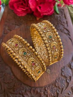 Elevate your traditional attire with our exquisite collection of Matt finish gold-plated Rajwada bangles. Each piece is a testament to craftsmanship, blending cultural richness with contemporary elegance. Our Indian jewelry ethnic kadas showcase timeless beauty, capturing the essence of tradition in every detail. Explore the allure of our temple jewelry-inspired bracelets, where heritage meets modernity. Embrace the legacy of fine craftsmanship with our traditional bangles, a celebration of Indian artistry that transcends time. Based on silver and copper alloy Highest quality and craftsmanship  You can pair these bangles with traditional banarsi sarees or lehengas. This will look great with zari silk sarees. We recommend you to wear this with pink or gold coloured saree. These bangles will Luxury Traditional Meenakari Bangle, Diwali Bollywood Style Bangle With Pallu, Ceremonial Toe Ring For Diwali, Yellow Gold Meenakari Bracelets For Festive Occasions, Yellow Gold Bracelets With Meenakari For Festive Occasion, Festive Tilla Bangle As Gift, Yellow Gold Festive Bracelet, Diwali Temple Jewelry Gold-plated Bracelets, Gold Plated Temple Jewelry Bracelet