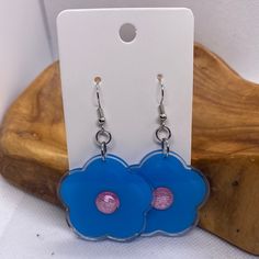 Handmade Blue Daisy Flower Earrings Silver Hook Earrings Blue/Purple Center Made in the USA Trendy Blue Flower Earrings, Blue Flower Charm Drop Earrings, Blue Flower-shaped Earrings With Ear Wire, Trendy Blue Flower Shaped Jewelry, Trendy Light Blue Dangle Earrings, Trendy Light Blue Drop Earrings, Blue Flower Earrings Nickel Free, Blue Drop Earrings With Flower Charm, Blue Drop Flower Earrings