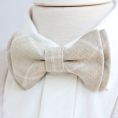 "Dapper Men's Natural Linen Windowpane Bow Tie Made By The Belle And The Beau! ♥ Beautiful linen/cotton blend yarn dyed woven fabric! Our dapper, modern, stylish, and charming neckties are perfect for everyday, Sunday best, all special occasions, photography sessions, and especially dapper on grooms and groomsmen! They are the perfect wedding accessory. We use the best cotton and cotton blend fabrics. We love that cotton is so versatile to dress up or down for any occasion. Each bow tie has a do White Dapper Ties For Black Tie Events, Dapper White Ties For Black Tie Events, Classic White Tie With Bow Tie Back, Dapper White Tie For Black Tie Events, Classic Summer Tie For Groom, White Bow Tie For Wedding, Adjustable Bow Tie For Groom, Summer, Dapper White Suit And Tie Accessories For Summer, Dapper White Suit And Standard Tie Accessories