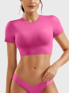 This adorable super-cropped top is designed to enhance your body proportions with a flattering fit. The double-layer lining ensures opacity, making it a versatile wardrobe essential for fitness, yoga, and casual outings.   Feature     Super Cropped Length  Short sleeve, breathability, and comfort  Double-lined, anti-see-through  Skin-friendly for body shaping  Versatile for any occasion     Fabric    73% Nylon + 27% Spandex    Model Measurements    Model Wear: S   Height: 173cm / 5'7"   Bust: 87 Solid Cropped Activewear With Built-in Bra, Medium Support Cropped Yoga Crop Top, Medium Support Cropped Top For Yoga, Stretch Crop Top For Pilates, Pink High Stretch Crop Top With Built-in Bra, Pink Crop Top With Built-in Bra And High Stretch, Fitted Cropped Crop Top For Pilates, Athleisure Crop Top With Built-in Bra And Scoop Neck, Athleisure Scoop Neck Crop Top With Built-in Bra