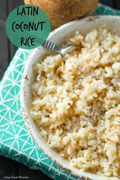 a bowl filled with rice next to a coconut on top of a green napkin and a fork