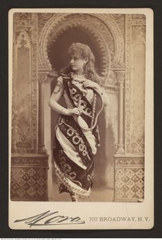 an old black and white photo of a woman in traditional dress, possibly from the early 1900's