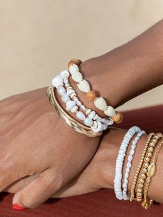 "Flaunting a mix of natural puka shells, luminous white pearls, and 14kt gold filled beads, this handmade Hawaiian shell bracelet acts as an exquisite reminder of the tranquil nature of Hawaii's calming waters. ✦ Choose from two sizes: Mini and Chunky ✦ ✦ DETAILS ✦ ✧ Name: Maka - (MAH kah) - favorite one. ✧ Adjustable Length from: 6.5\"-8\" ✧ Mini: 6-7mm width; Chunky: 9-10mm width. ✧ White Freshwater Pearls. ✧ Puka Seashells. ✧ 14kt Gold Filled Components, Extender, and Clasp. ✧ All Ke Aloha Je Stackable Beaded Bracelets For Beach, White Ocean-inspired Jewelry With Round Beads, Ocean-inspired White Round Bead Jewelry, Ocean-inspired White Round Beaded Jewelry, White Shell Bracelets As A Gift, White Shell Bracelets Perfect For Gifts, Adjustable White Pearl Bracelet For Beach, White Bohemian Shell Bracelet, Ocean-inspired White Beaded Jewelry