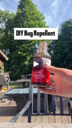 a person holding up a bottle of bug repellent with the words diy bug repellent on it