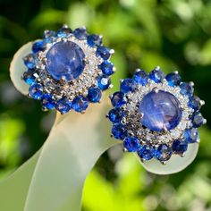 - Statement sapphire diamond earring  - Burmese natural vivid blue cabochon sapphire (2pcs)(2.30ct), semi round mix cut sapphire (32pcs)(2.80ct) Total sapphire weight (5.10ct) Brilliant round cut diamond (30pcs) - Set with 18k yellow gold (7.913g) Dazzling Blue Diamond Earrings, Blue Sapphire Oval Diamond Earrings, Luxury Sapphire Diamond Earrings With Brilliant Cut, Luxury Blue Diamond Earrings With Prong Setting, Sapphire Diamond Earrings With Gemstone Detail, Luxury Tanzanite White Gold Earrings, Luxury White Gold Tanzanite Earrings, Oval Sapphire Earrings With 17 Jewels, Luxury Tanzanite Earrings With Gemstone