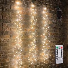 a brick wall with some lights on it and a remote control in front of it