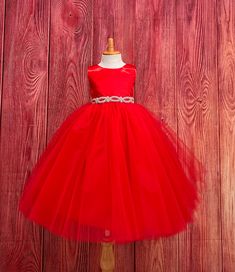 Red 4 Layer Tulle-Ankle Length Dress  This classic beautiful, elegant dress is one of my favorite! So modern and classy for any special occasion. The bodice is made of Red bridal satin, a hidden zipper can be found on the back of the dress, followed by an elegant rhinestone band at the waistline (not removable) The skirt consist of 4 Red Tulle layers and two layers of lining followed by crinoline for a fuller look. If you are interested in a specific color to match your color scheme please message me! Dress is pictured with Petticoat to show full detail. NOT INCLUDED https://www.etsy.com/listing/1305138635/white-ankle-length-petticoat-wedding?click_key=79499b8045349abec4d15e286ce2a8958c22127e%3A1305138635&click_sum=143c4c83&ref=shop_home_active_2&sts=1 Visit our store, more items to come! Elegant Christmas Tulle Tutu Dress, Elegant Christmas Tutu Dress In Tulle, Elegant Red Pageant Dress For Prom, Red Princess Ball Gown For Holiday, Princess Red Ball Gown For Holidays, Red Princess Ball Gown For The Holidays, Elegant Holiday Tutu Dress, Elegant Tutu Dress For Holiday Pageants, Elegant Tulle Ball Gown For Christmas