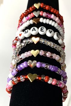 Stacking boho valentine bracelets. You chose the beads, personalization, and heart bead color. These adorable and trendy stacking seed beads bracelets make great gifts. Heart beads are metal and come in silver, gold, or rose color colors. This listing is for ONE bracelet. Pictures are examples. Your choices Style: Plain - Seed beads only With Heart - Seed beads and your choice of heart bead With Name - Seed beads with personalization and red heart beads surrounding the name. Seed bead colors: Al Valentine Bracelets, Seed Beads Bracelets, Bracelet Pictures, Boho Valentine, Valentines Bracelets, Toddler Gift, Beads Bracelets, Girl Toddler, Valentines Day Gifts For Her